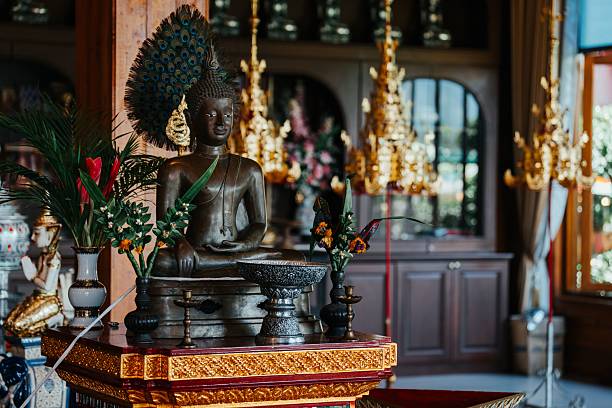 istock Buddha statue with offerings in temple. 2207913310