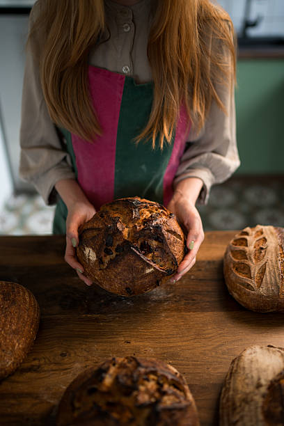istock Baker holding freshly baked sourdough bread in hands 2207915013