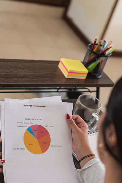 istock Marketing professional analyzing budget allocation report at home office 2207918090