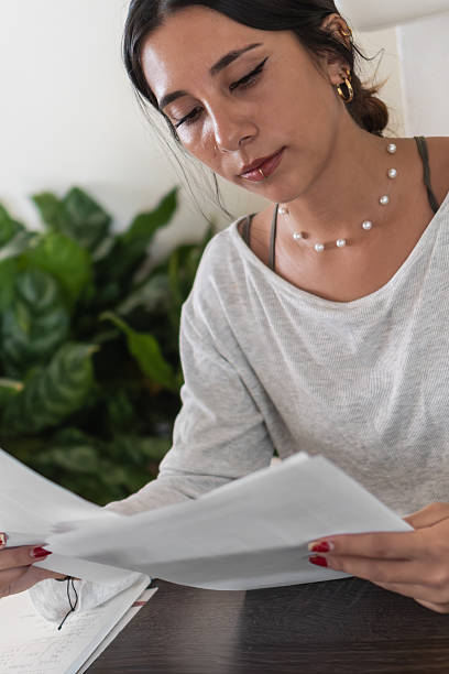 istock Young hispanic businesswoman working from home checking paperwork 2207918139