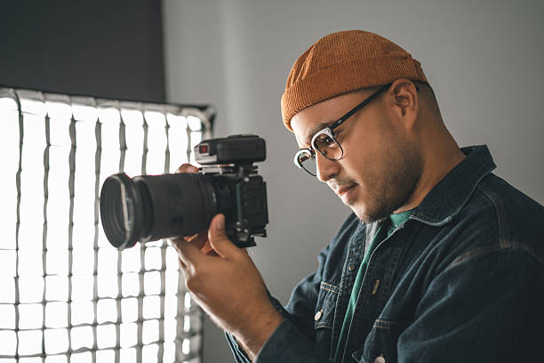 istock Professional man photographer working shooting woman model using digital camera and flash studio in studio on white background. photography concept. 2207918228