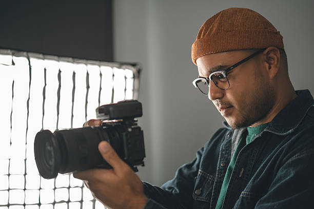 istock Professional man photographer working shooting woman model using digital camera and flash studio in studio on white background. photography concept. 2207919110