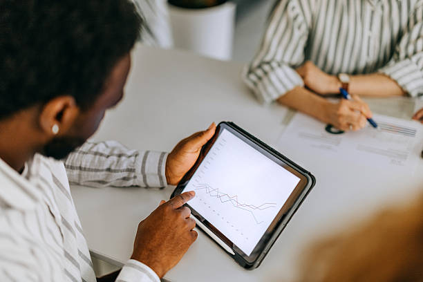 istock Young businessman using a digital tablet during a meeting in the boardroom 2207921064
