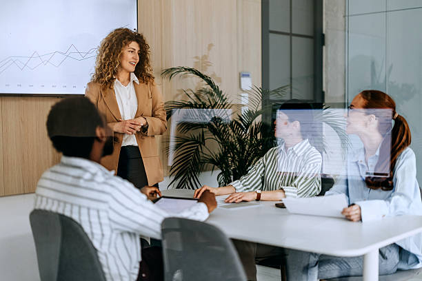 istock Female CEO analysing business performance with team 2207921179