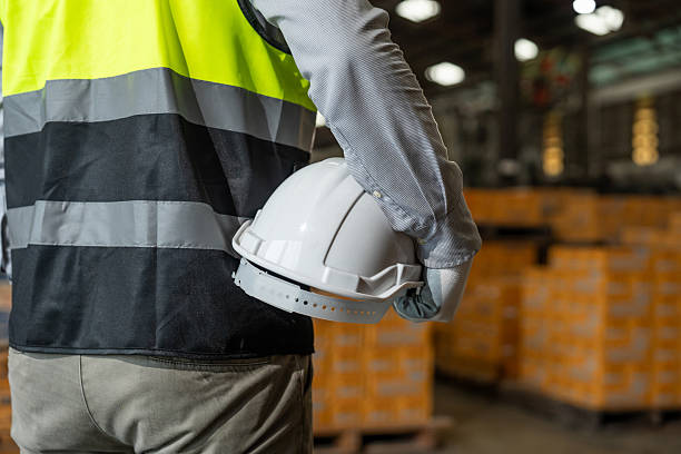 istock Close up technician engineer wearing and adjust protective safety helmet or hard hat. Safety equipment for industry factory. Safety at work concept. 2207921732