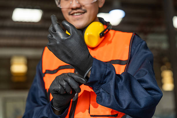 istock Close up technician engineer wearing and adjust protective safety glove. Safety equipment for industry factory. Safety at work concept. 2207921735