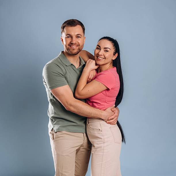 istock Embracing, standing and posing. Man and woman are in the studio 2207922034
