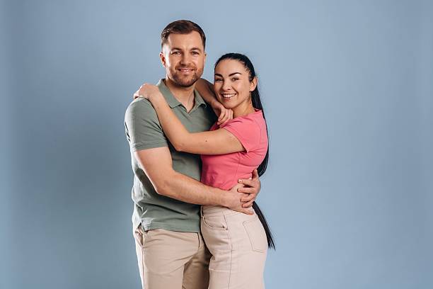 istock Embracing, standing and posing. Man and woman are in the studio 2207922044
