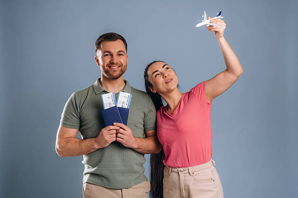 istock Documents and tickets are ready, vacation conception. Man and woman are in the studio 2207922142