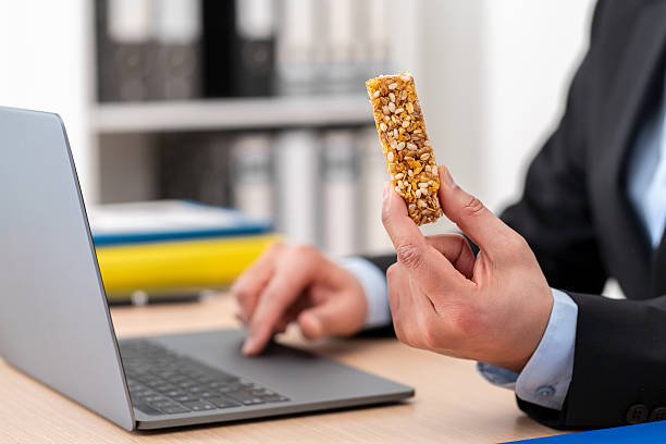 istock business man working on laptop holding snack bar 2207923783