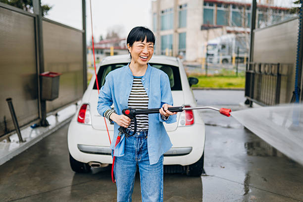 istock Women at self service car wash 2207923809