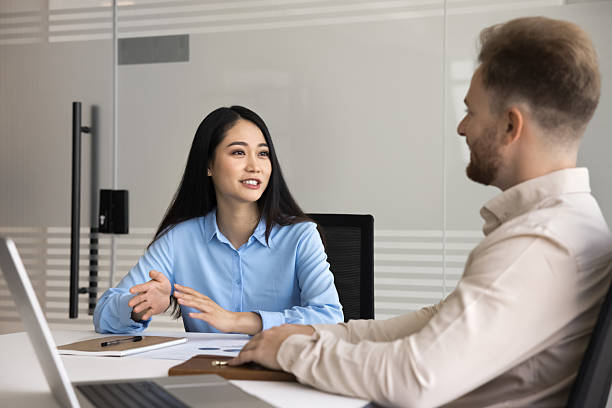 istock Positive young Asian manager talking to boss 2207925519