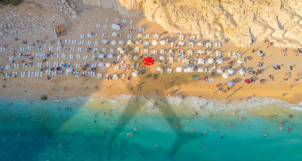 istock Aerial view airplane shadow and beach 2207925520