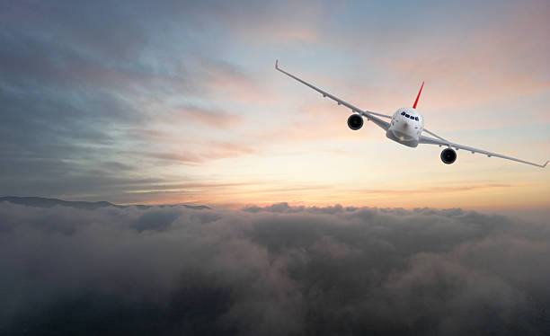 istock Commercial airplane flying above clouds at sunset. 2207925527
