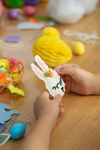 istock Easter crafting activity with felt bunny and colorful decorations for kids. Easter. DIY 2207926025