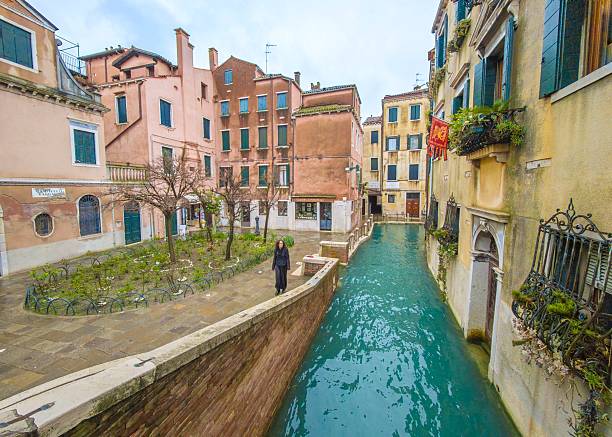 Venice, Italy - 15 March 2025 - The city on the sea, with the most characteristic places and touristic attractions in the world. Here in particular a landmark view: a little water canal