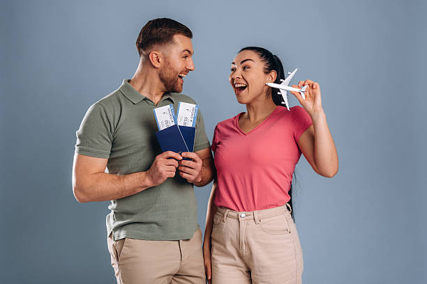 istock Flying time, vacation conception, with tickets. Man and woman are in the studio 2207926642