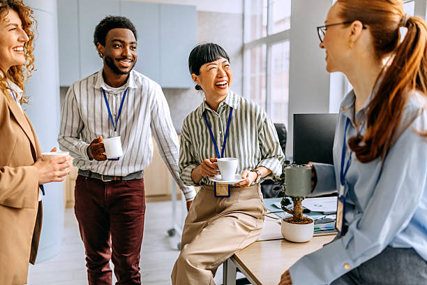 istock Coworkers talking and drinking coffee at office 2207927238
