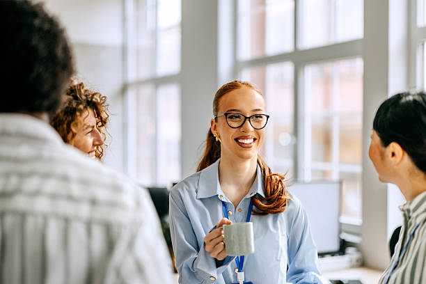 istock Smiling colleagues talking during coffee break at the office 2207927257