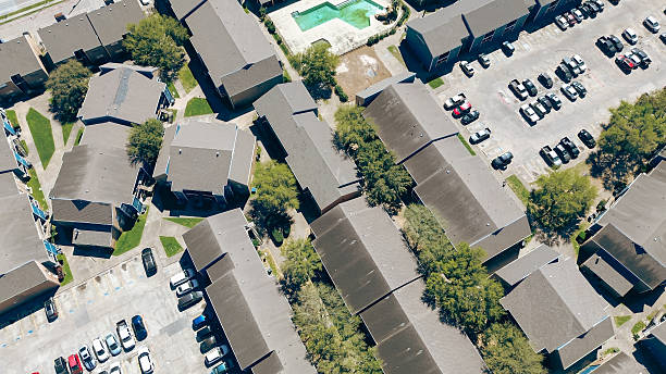 istock Modern multistory apartment complex with swimming pool, uncovered parking lot, shingle roofing along Corporate Drive in fast-growing housing market area, Chinatown, Houston, Texas, aerial view 2207927265