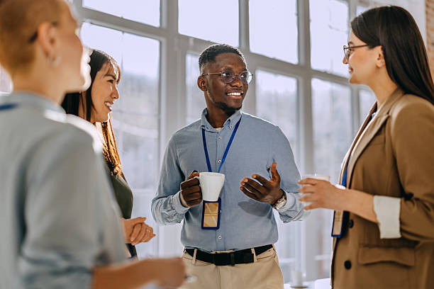 istock Four colleagues casually talking during a coffee break at a conference 2207928072