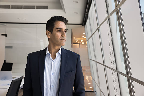 istock Thoughtful company director man in formal jacket posing in office 2207928134