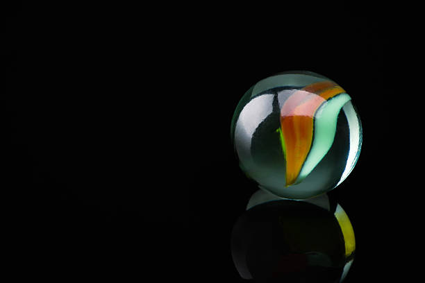 Colored glass marbles ball on black background