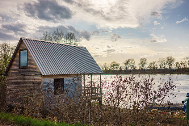 Small wooden houses by the river Sava in Serbia. Early spring, cloudy but nice weather.