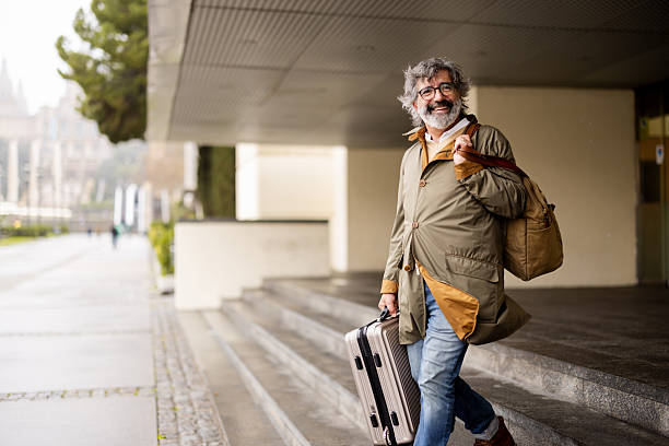 istock Mature traveler exiting a train station with a smile on his face 2207929193