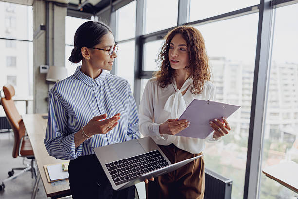 istock A Collaborative Effort Between Two Women in a Contemporary Modern Office Environment Setting 2207930386