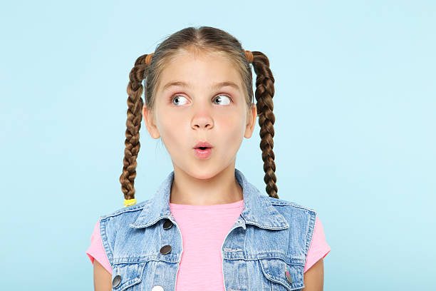 istock Young surprised girl on blue background 2207930468