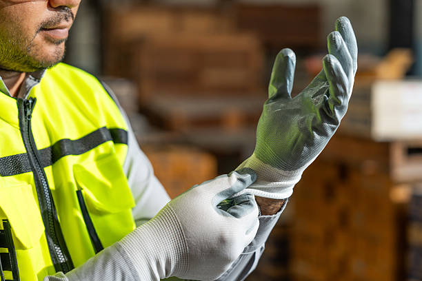 istock Close up technician engineer wearing and adjust protective safety glove. Safety equipment for industry factory. Safety at work concept. 2207931653