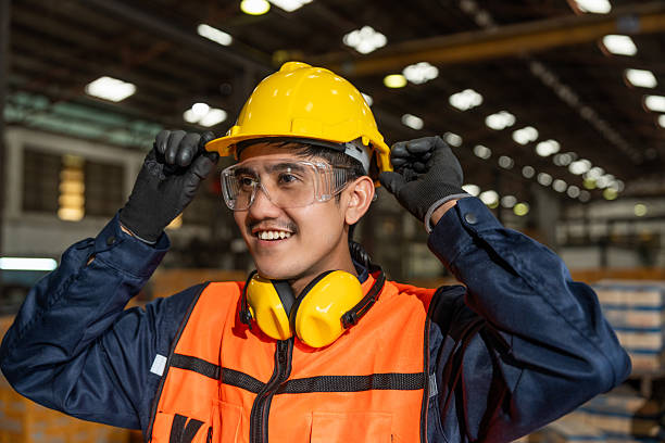 istock Close up technician engineer wearing and adjust protective safety helmet or hard hat. Safety equipment for industry factory. Safety at work concept. 2207932954