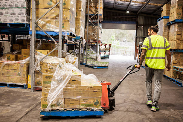 istock Warehouse Employee Using Pallet Jack to Transport Goods 2207933639
