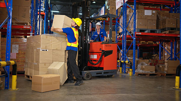 istock A group of warehouse workers were involved in an accident while on duty, Coworkers offered assistance and first aid 2207933698