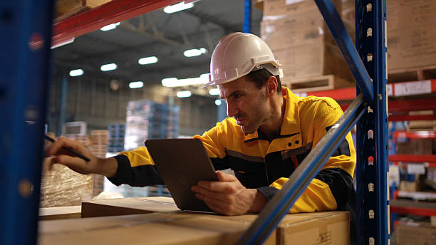 istock Warehouse workers are reviewing the list of items based on the documentation 2207933727