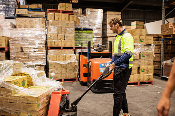 istock Warehouse Employee Using Pallet Jack to Transport Goods 2207934025