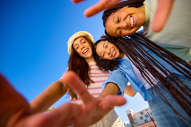 istock Three teenager girls hugging and smiling at camera from below 2207935537