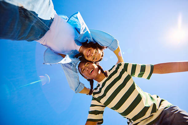 istock Two Gen Z friends are supporting each other and smiling at camera from below 2207935545