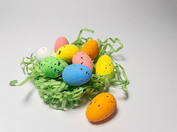 Small speckled multicolored eggs set close-up on a white background, isolated. Top view