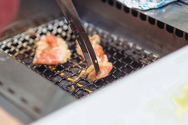 istock Raw Beef being grilled in Barbeque grill 2207938829