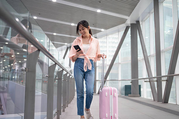 istock Adventure Awaits: A Woman’s Happy Journey Through the Airport 2207942458