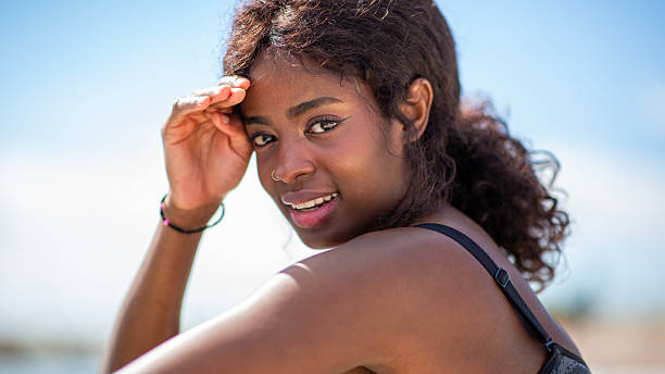 istock african woman shields her eyes from the sun 2207942500
