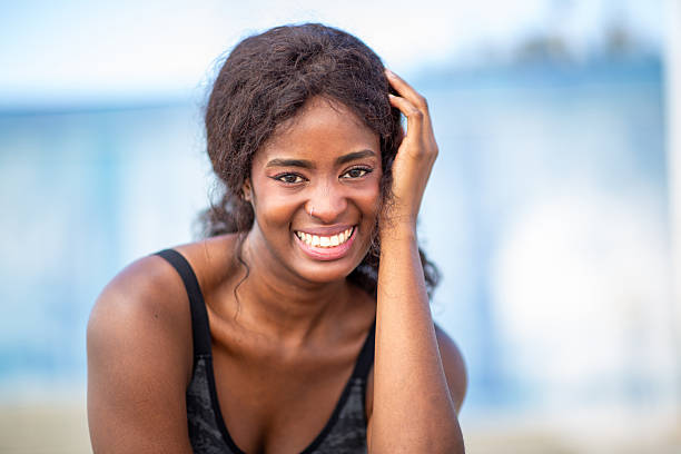 Close up portrait young woman smiling and looking at camera
