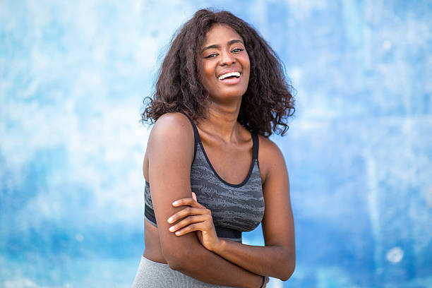 istock woman with arms crossed by blue background 2207942537