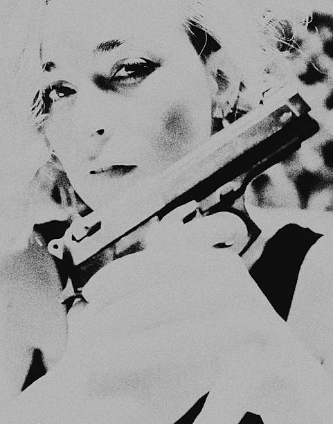 Woman Holding Gun Against White Background