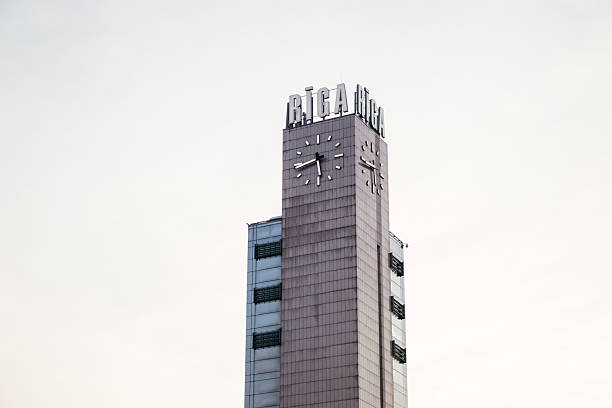A modern clock tower in Riga, Latvia, standing tall against a soft sky, representing urban elegance and architectural minimalism. High quality photo