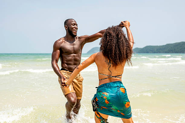 istock Joyful Couple Dancing on the Beach in Summer Sunlight 2207944197