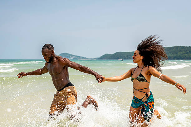 istock Joyful Couple Running and Splashing in Ocean Waves 2207944202