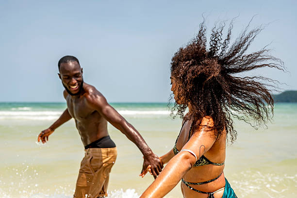 istock Happy Couple Enjoying a Fun Day at the Beach 2207944221